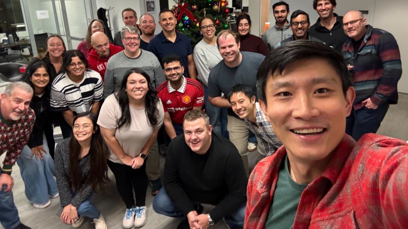 A group photo of Possible Finance employees from the angle of a selfie. 